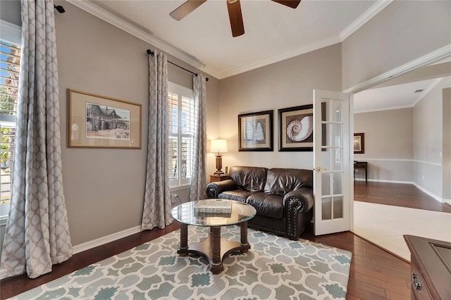 living room with french doors, ceiling fan, crown molding, and dark wood-type flooring