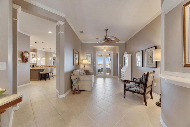 living room with light tile patterned floors, ornamental molding, and ceiling fan