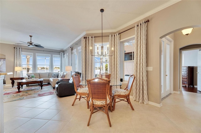 dining room with crown molding, ceiling fan with notable chandelier, and light tile patterned floors