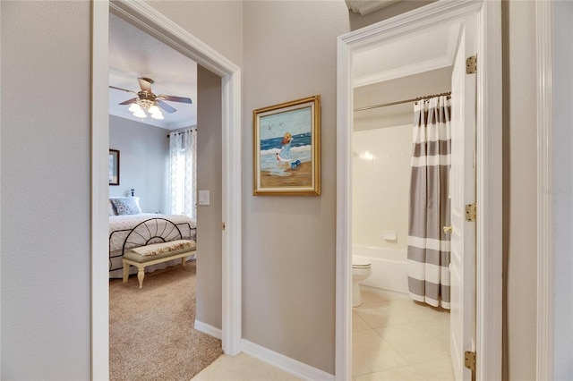 corridor featuring crown molding and light colored carpet