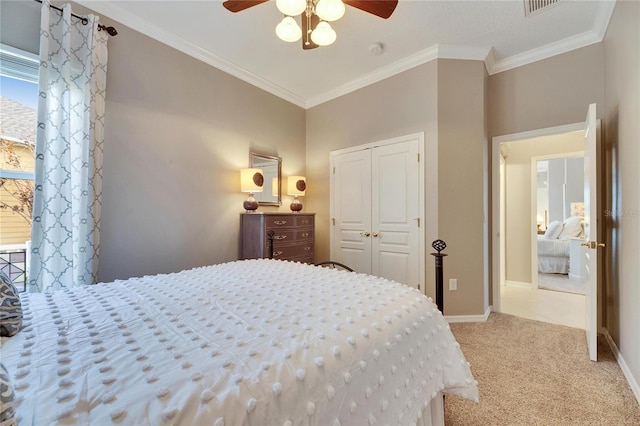 bedroom with crown molding, light colored carpet, a closet, and ceiling fan