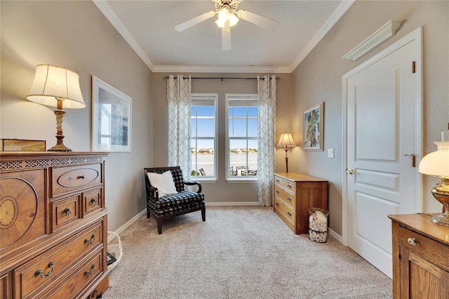 living area featuring crown molding, light colored carpet, and ceiling fan