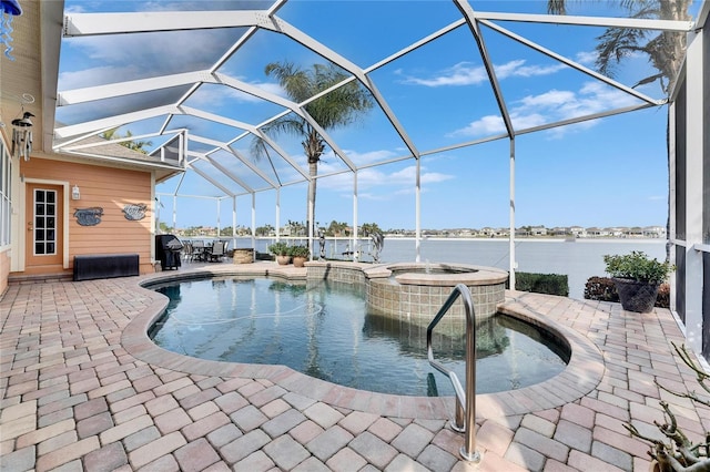 view of swimming pool with a lanai, a patio, a water view, and an in ground hot tub