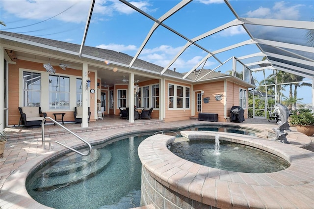 view of pool with ceiling fan, glass enclosure, a patio area, area for grilling, and an in ground hot tub