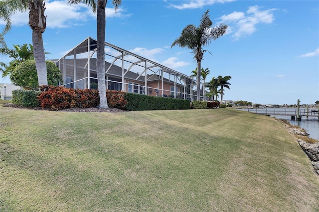 exterior space featuring a water view and glass enclosure