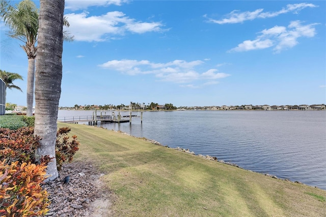 dock area featuring a water view and a yard