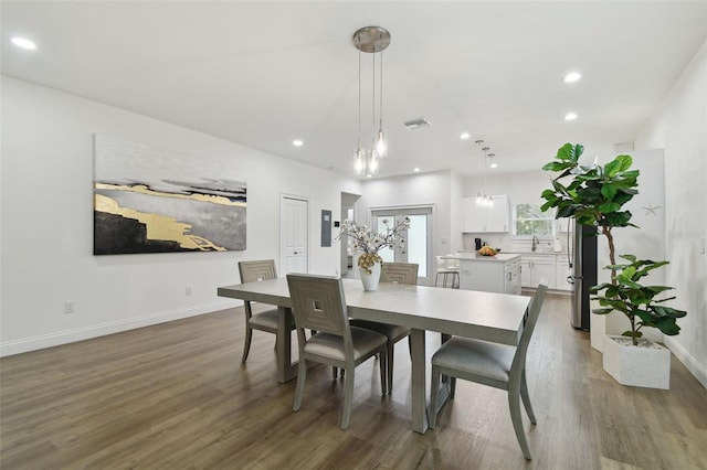 dining area with dark wood-type flooring and sink