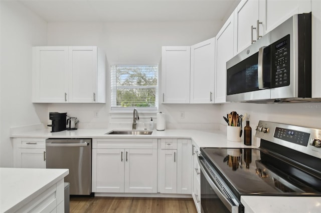 kitchen with white cabinetry, sink, and stainless steel appliances