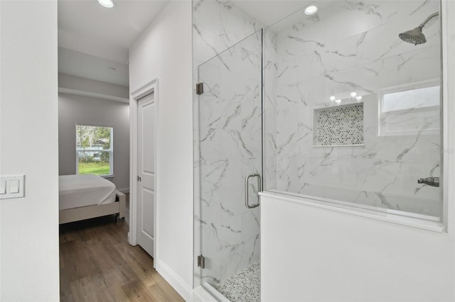 bathroom featuring walk in shower and hardwood / wood-style flooring