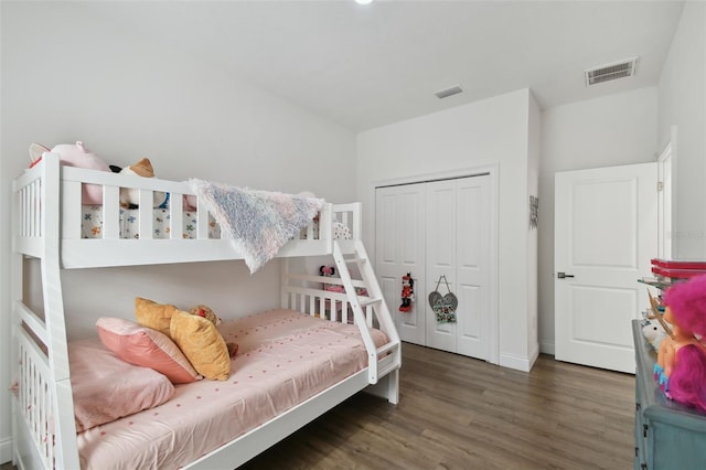 bedroom with a closet and dark hardwood / wood-style floors