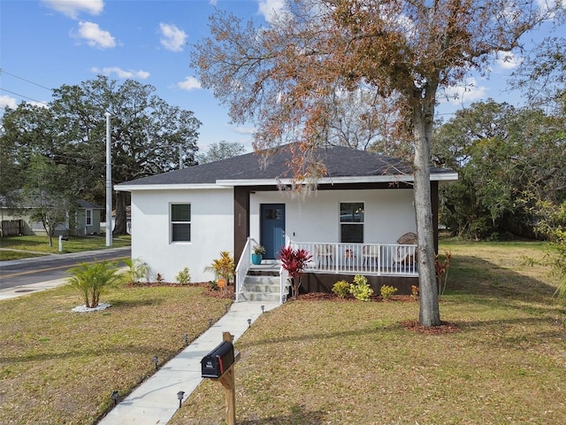 view of front of home with a front yard and a porch