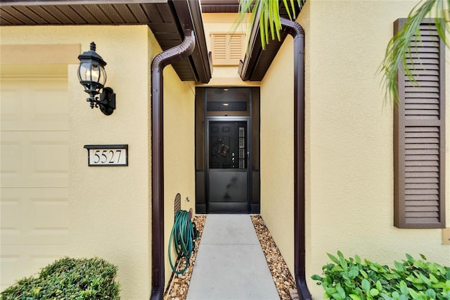 view of exterior entry with a garage