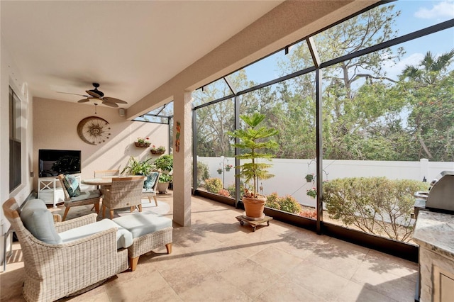 sunroom / solarium featuring ceiling fan