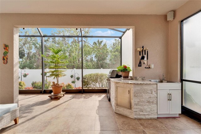 sunroom / solarium with sink and plenty of natural light