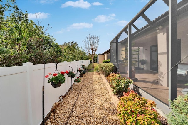 view of yard with glass enclosure