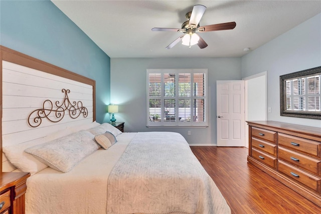 bedroom with dark hardwood / wood-style floors and ceiling fan