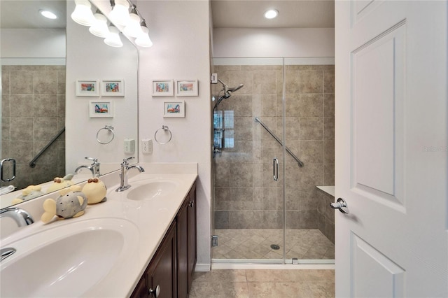 bathroom featuring vanity and a shower with door