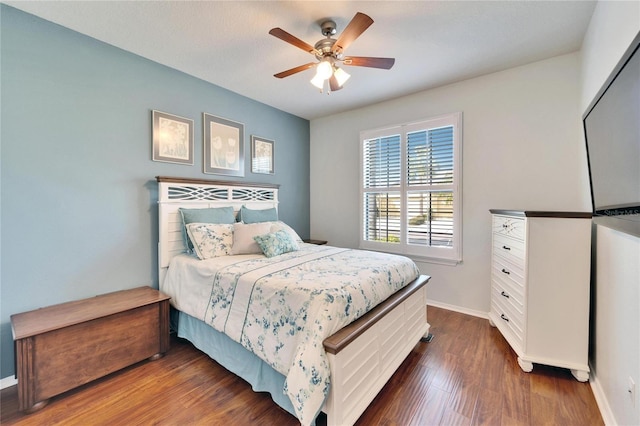 bedroom with dark hardwood / wood-style flooring and ceiling fan