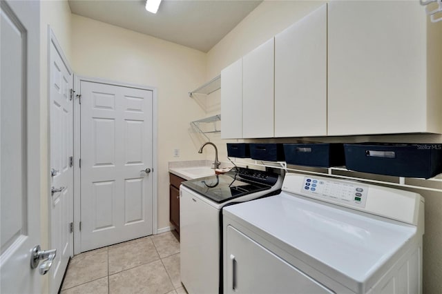 washroom featuring cabinets, separate washer and dryer, sink, and light tile patterned floors