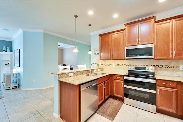 kitchen featuring sink, appliances with stainless steel finishes, tasteful backsplash, decorative light fixtures, and kitchen peninsula