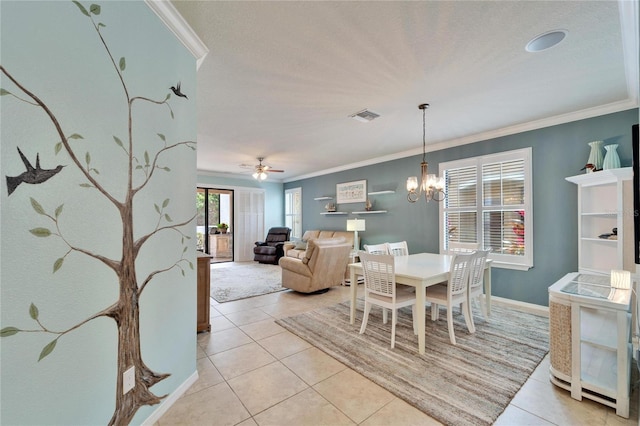 tiled dining area featuring crown molding and ceiling fan with notable chandelier