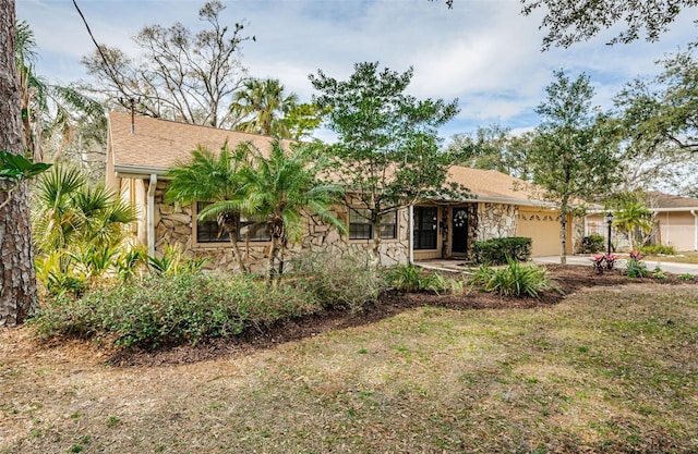 single story home featuring a garage and a front lawn