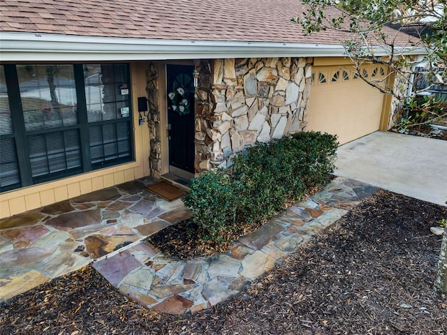 doorway to property with a garage