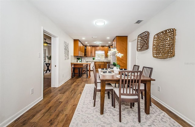 dining room with hardwood / wood-style floors, sink, and ceiling fan