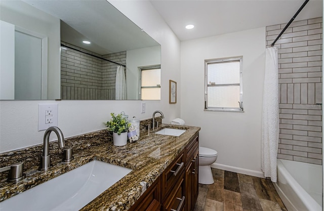 full bathroom with vanity, wood-type flooring, toilet, and shower / bath combo with shower curtain