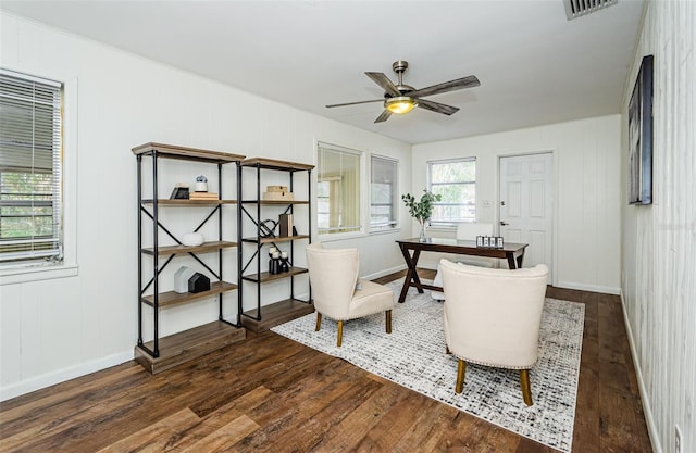 home office with ceiling fan and dark hardwood / wood-style flooring