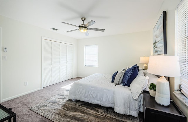 carpeted bedroom with ceiling fan and a closet