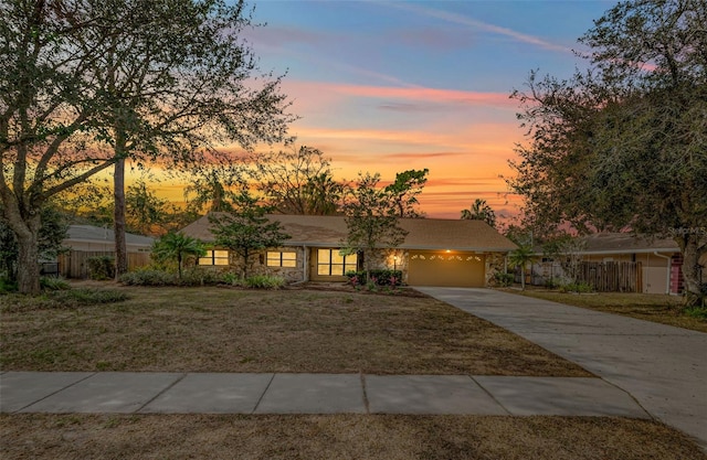 view of front of property featuring a garage and a yard