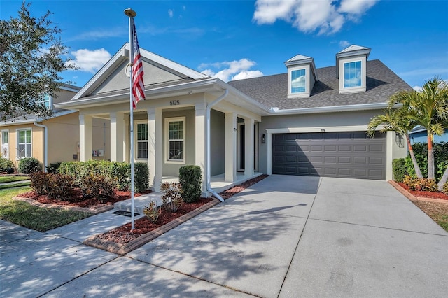 view of front of home featuring a porch and a garage