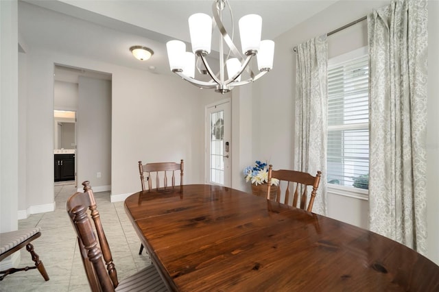 tiled dining space with a chandelier