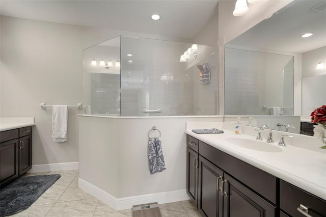 bathroom featuring vanity and tiled shower