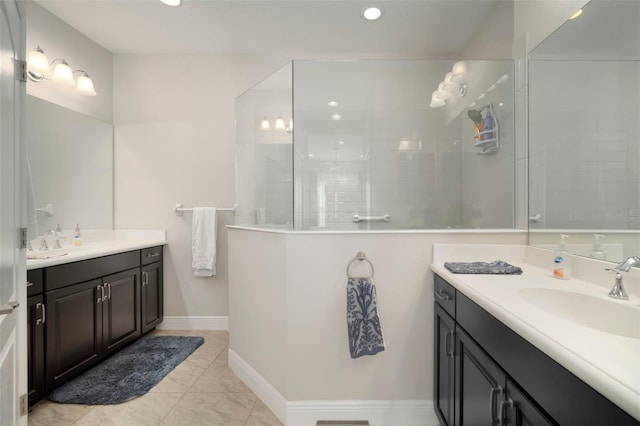 bathroom with vanity, tile patterned flooring, and tiled shower