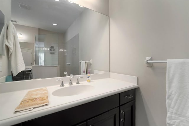 bathroom featuring vanity and a tile shower