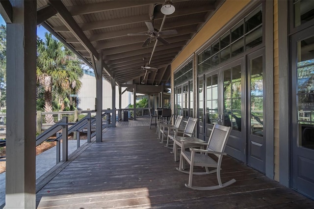 wooden terrace featuring ceiling fan and french doors