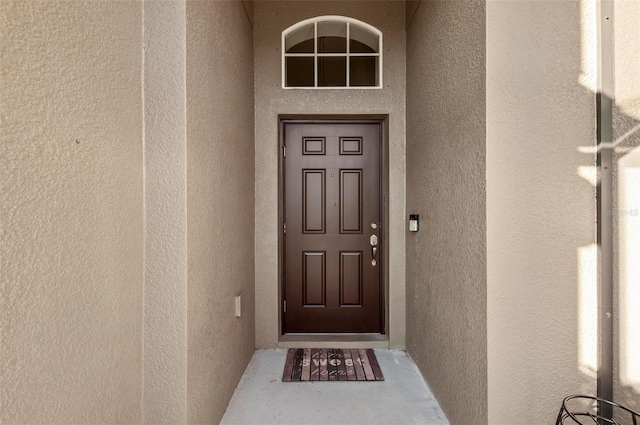 property entrance featuring stucco siding