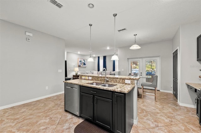 kitchen with french doors, visible vents, stainless steel dishwasher, a sink, and an island with sink