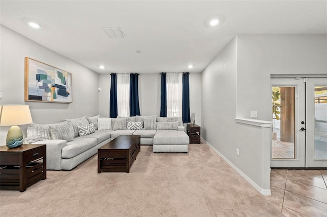 living room featuring light carpet, visible vents, baseboards, french doors, and recessed lighting