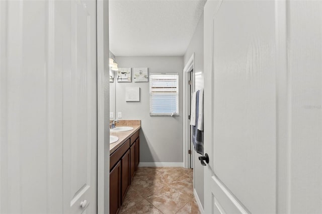 bathroom featuring vanity and a textured ceiling