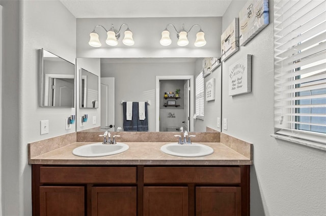 full bath with double vanity and a sink