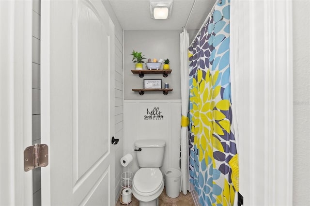 bathroom with toilet and wainscoting