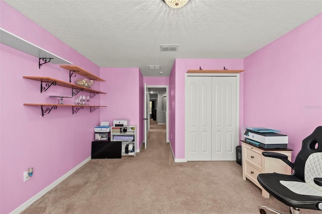 home office featuring baseboards, light colored carpet, visible vents, and a textured ceiling