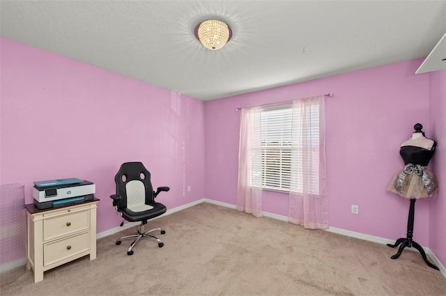 office area featuring light colored carpet, a textured ceiling, and baseboards