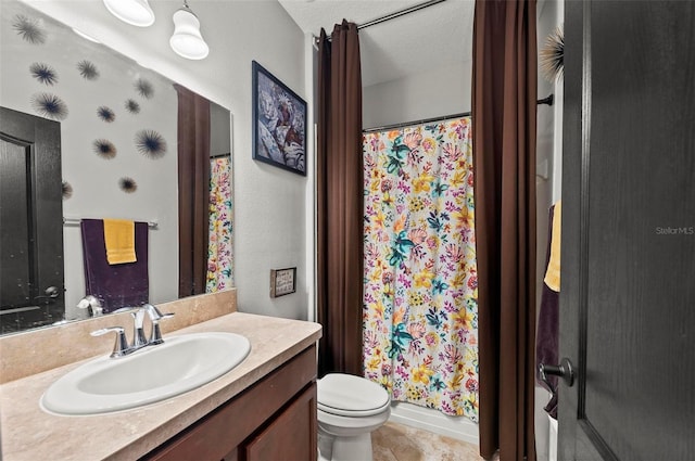 bathroom with vanity, a textured ceiling, a shower with curtain, and toilet