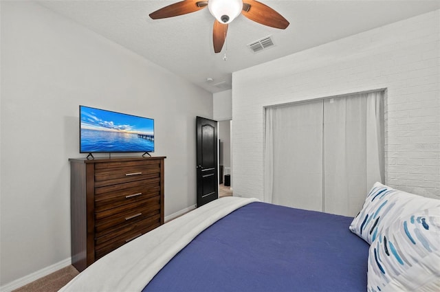 carpeted bedroom featuring ceiling fan, a textured ceiling, visible vents, baseboards, and a closet