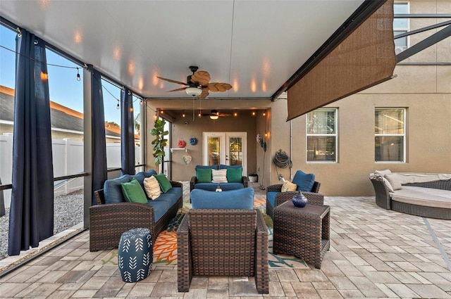 sunroom / solarium with a wealth of natural light, french doors, and ceiling fan