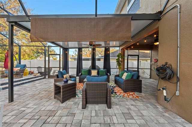 view of patio featuring ceiling fan, fence, an outdoor living space, and a lanai